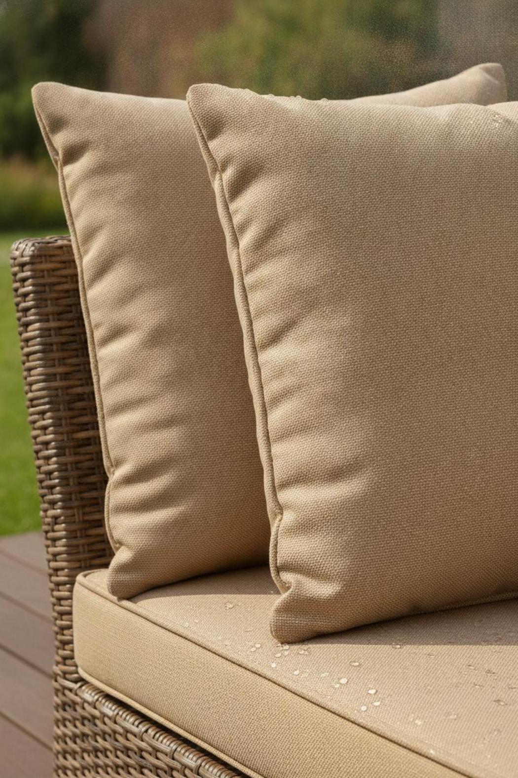 Close-up of weather-resistant Sunbrella fabric on rattan furniture cushions replacement set with dew drops in natural light