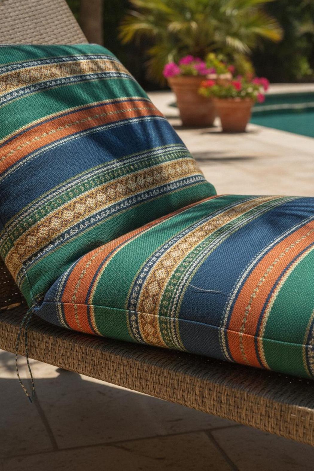 Close-up of sunbrella outdoor fabric for patio cushions draped on rattan chair, showing tight weave and acrylic fiber sheen
